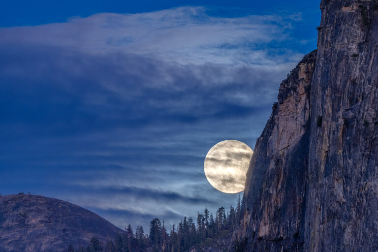 Yosemite National Park, California A full moon rises in Yosemite Valley as seen from Tunnel View.