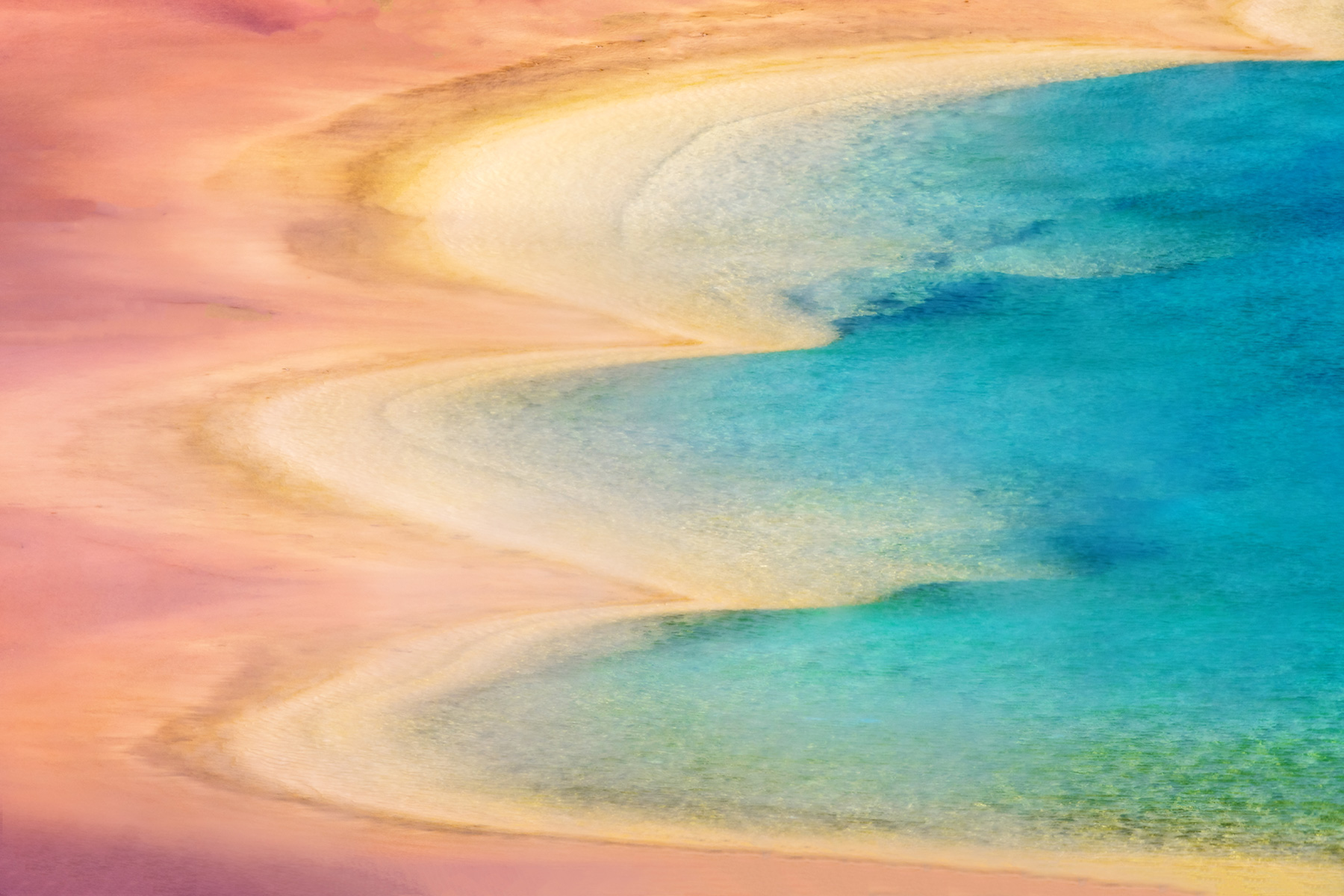 Yellowstone National Park, Wyoming The colors surrounding Grand Prismatic Spring appear to melt into each other, creating a beautiful edge. These colorful hues result from heat-loving bacteria thriving in and around the spring, with different colors corresponding to varying temperatures.