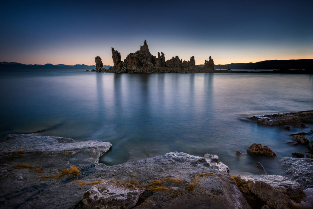 A coastal landscape photograph edited using Adobe Lightroom's Select Landscape masking tool, showcasing enhanced sky, water, and terrain separation.