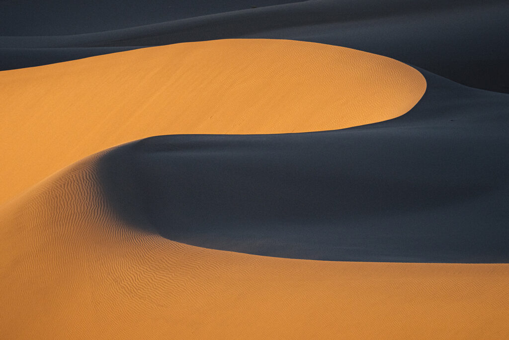 Photo of Wind-molded Ibex Dunes displaying classic s-shaped forms.